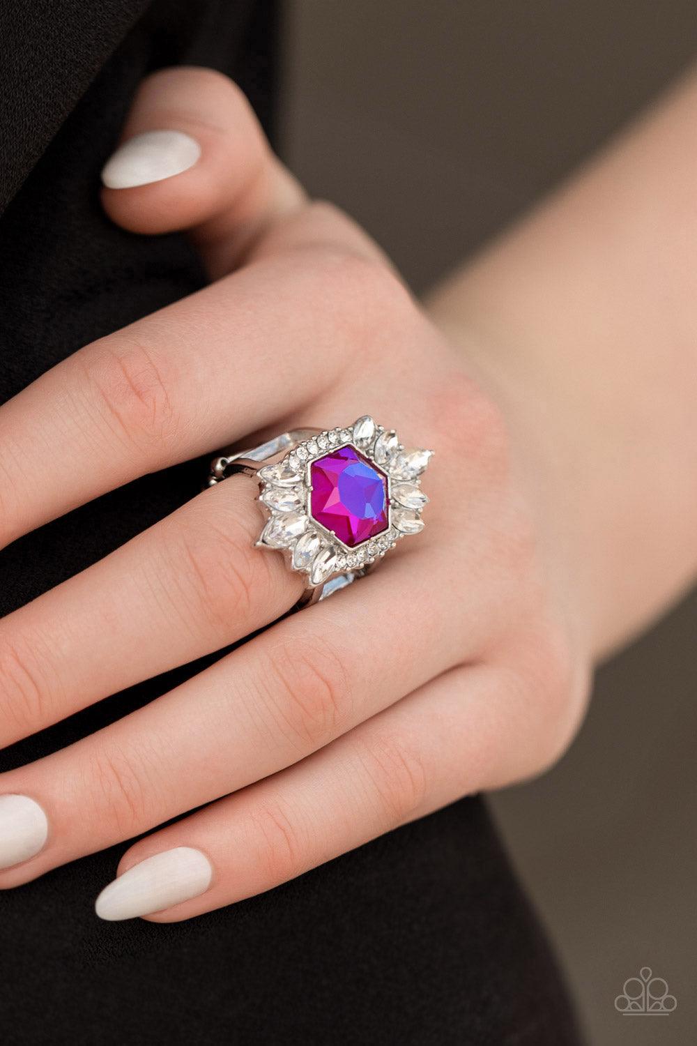 Paparazzi Accessories Divine Intervention - Pink Featuring a radiant UV shimmer, a hexagonal pink rhinestone is pressed into the center of round and marquise cut white rhinestones that dramatically coalesce into an out-of-this-world centerpiece atop the f