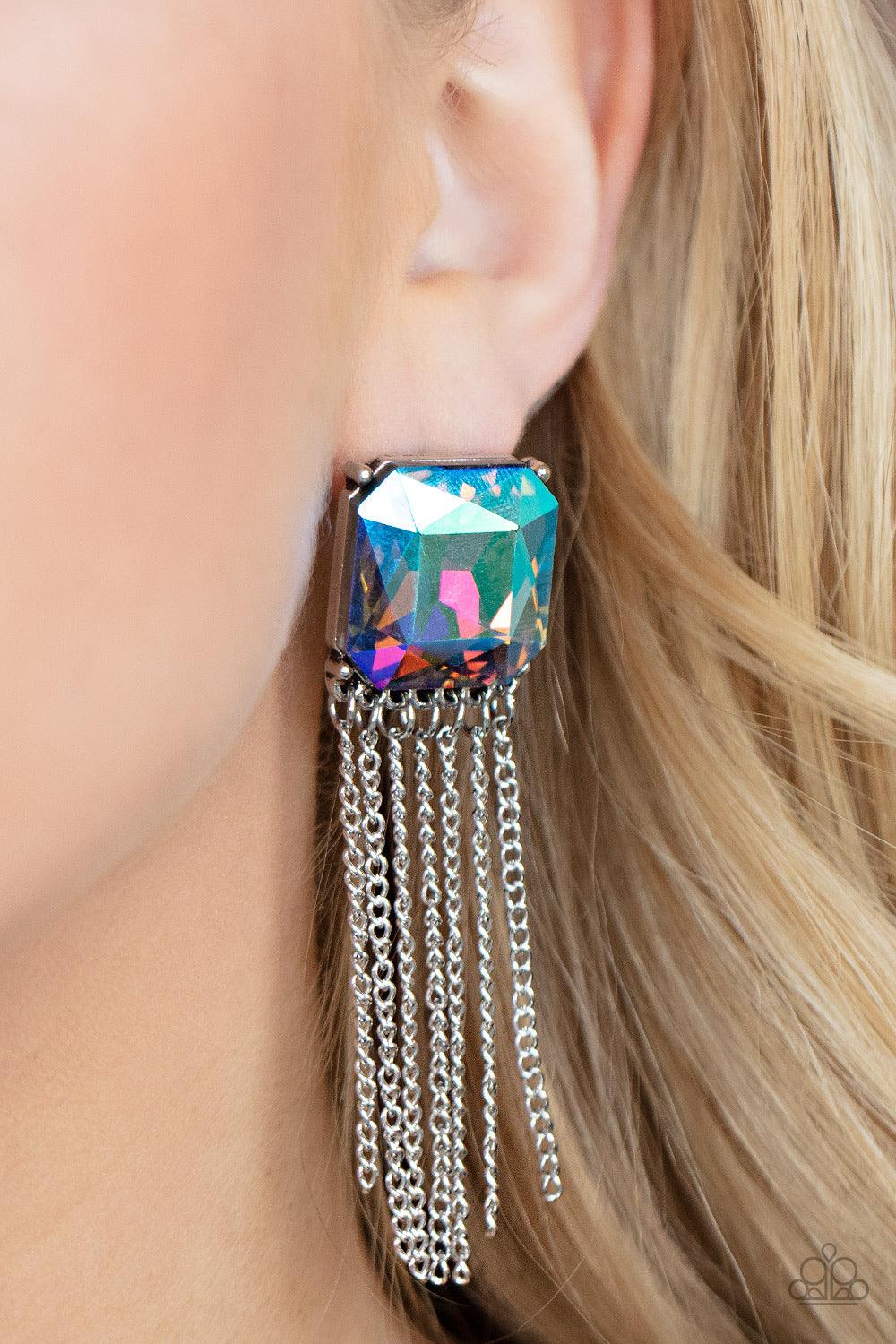 Paparazzi Accessories Supernova Novelty - Multi Featuring a stellar UV shimmer, an oversized radiant cut gem is pressed into a pronged silver fitting that gives way to a tapered curtain of silver chains for an out-of-this-world finish. Earring attaches to