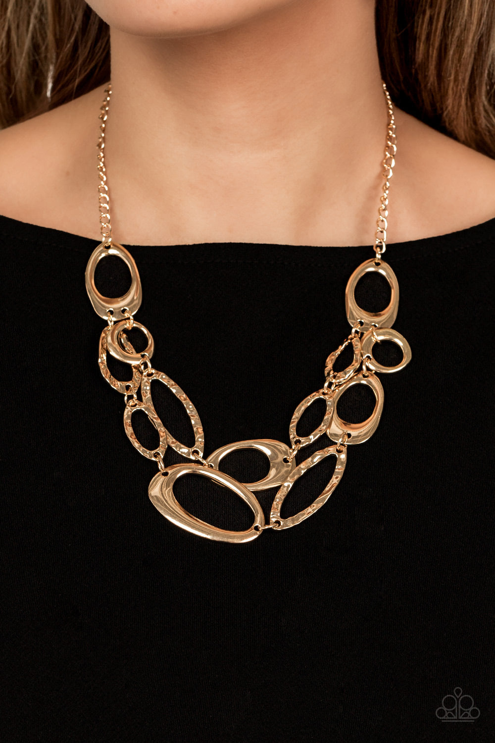 Paparazzi Accessories Game OVAL - Gold A mismatched assortment of asymmetrical and hammered gold ovals delicately links below the collar, creating refined metallic layers. Features an adjustable clasp closure. Sold as one individual necklace. Includes one