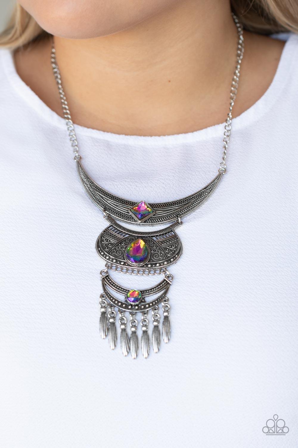 Paparazzi Accessories Lunar Enchantment - Multi Embossed in studded, geometric, and paisley filigree-like patterns, three mismatched silver half moon plates dramatically link below the collar. Featuring an iridescent UV shimmer, an oversized collection of