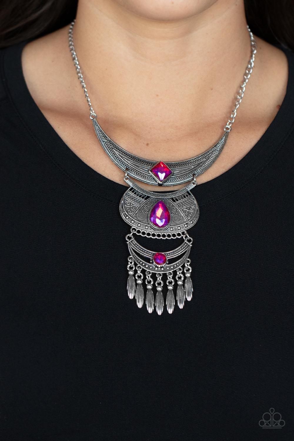 Paparazzi Accessories Lunar Enchantment - Pink Embossed in studded, geometric, and paisley filigree-like patterns, three mismatched silver half moon plates dramatically link below the collar. Featuring an entrancing pink UV shimmer, an oversized collectio
