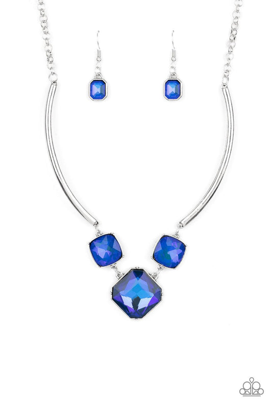 Paparazzi Accessories Divine IRIDESCENCE - Blue Featuring a subtle UV shimmer, an oversized collection of radiant cut blue gems delicately link at the bottom of two curved silver rods. Attached to shiny silver chains, the glamorously glitzy display sparkl