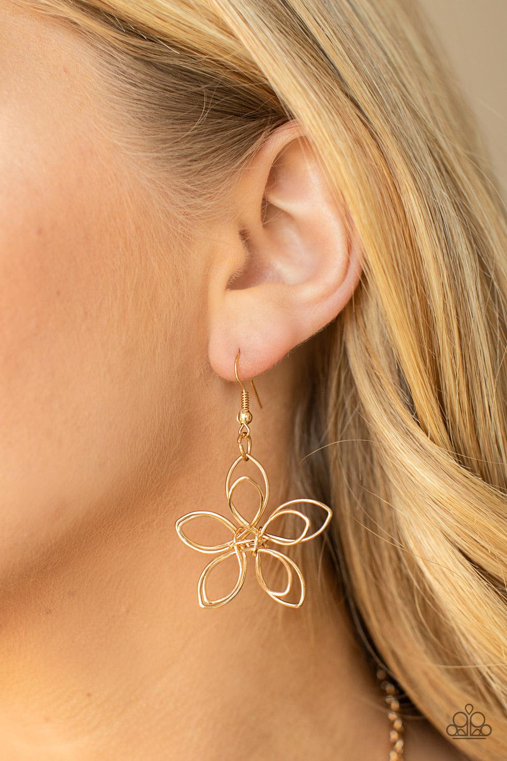 Paparazzi Accessories Flower Garden Fashionista - Gold Shiny gold wire delicately twists into oversized blossoms. Varying in size, the airy floral frames delicately link into an asymmetrical display as the layered frames elegantly pop beneath the collar.
