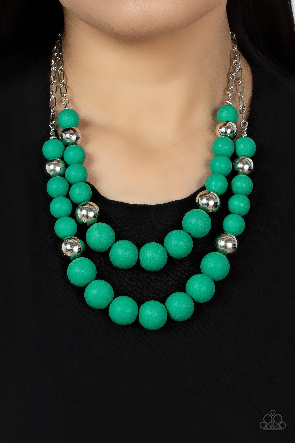 Paparazzi Accessories Vivid Vanity - Green Gradually increasing in size, two oversized rows of silver and Leprechaun beads layer into two bubbly layers below the collar. Features an adjustable clasp closure. Sold as one individual necklace. Includes one p
