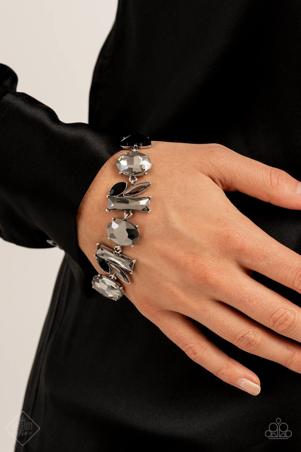 Paparazzi Accessories Marvelously Modish - Silver Featuring edgy pronged settings and antiqued silver frames, a mismatched collection of lustrous hematite, smoky, and black rhinestones in various shapes and sizes unite into a gritty modern mashup around t