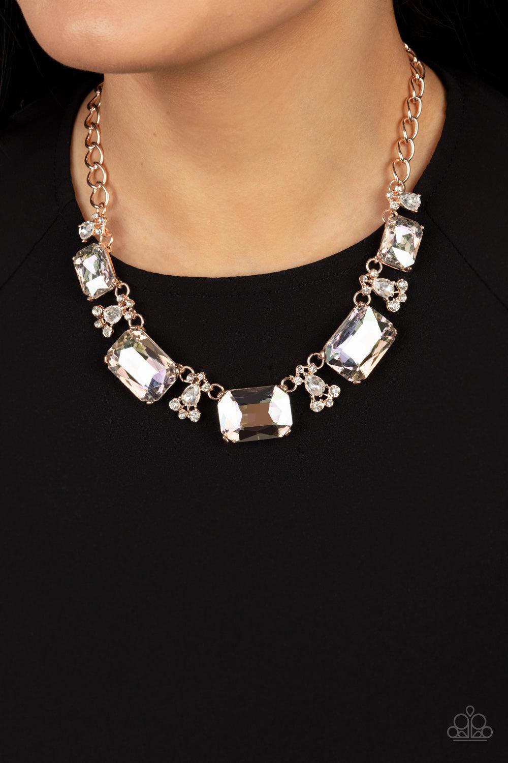 Paparazzi Accessories Flawlessly Famous - Multi Encased in sleek rose gold fittings, an oversized collection of emerald cut white rhinestones link with rhinestone dotted teardrop rhinestone frames below the collar for a jaw-dropping display. Features an a