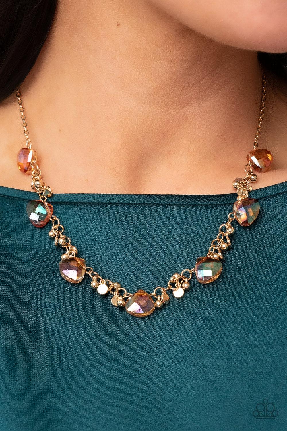 Paparazzi Accessories Sassy Super Nova - Gold Dainty clusters of gold beads and gold discs connect with iridescent gold gems below the collar, resulting in a stellar fringe. Features an adjustable clasp closure. Sold as one individual necklace. Includes o