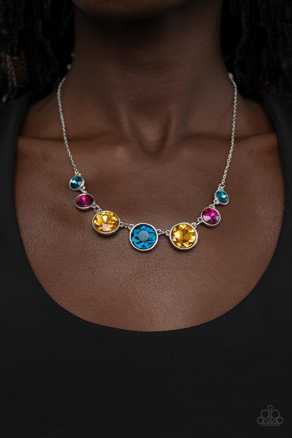 Paparazzi Accessories Pampered Powerhouse - Multi Encased in shiny silver frames, a glitzy collection of blue, yellow, and pink rhinestones gradually increase in size as they link below the collar for a flawless finish. Features an adjustable clasp closur