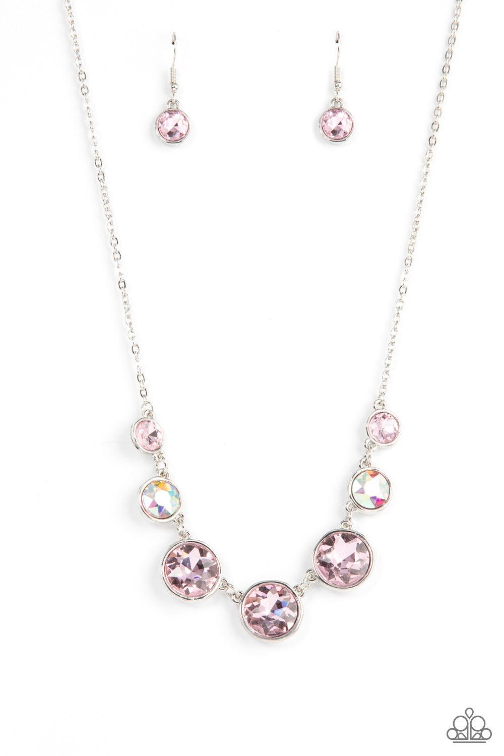 Paparazzi Accessories Pampered Powerhouse - Pink Encased in shiny silver frames, a glitzy collection of pink and iridescent gems gradually increase in size as they link below the collar for a flawless finish. Features an adjustable clasp closure. Sold as