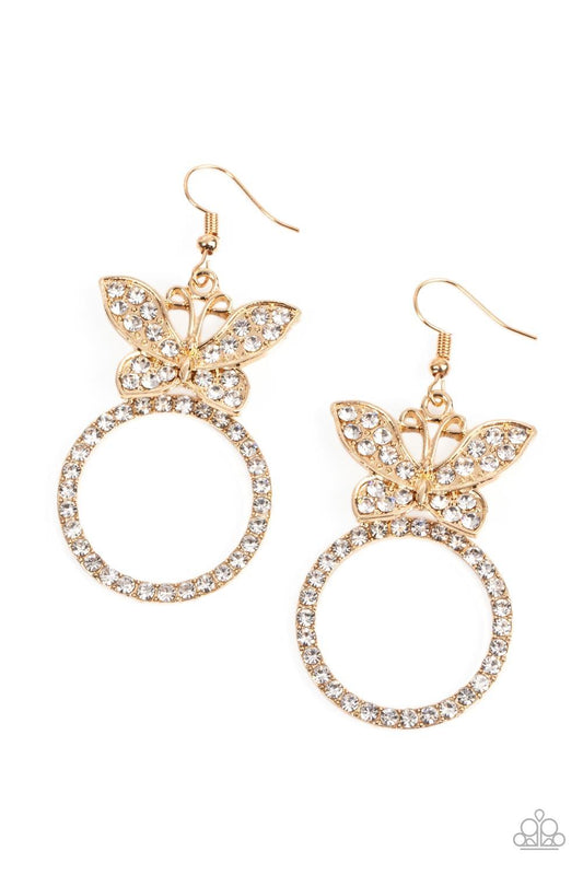 Paparazzi Accessories Paradise Found - Gold A white rhinestone encrusted gold butterfly flutters atop a gold ring dotted in matching white rhinestones, resulting in a dazzling statement piece. Earring attaches to a standard fishhook fitting. Sold as one p
