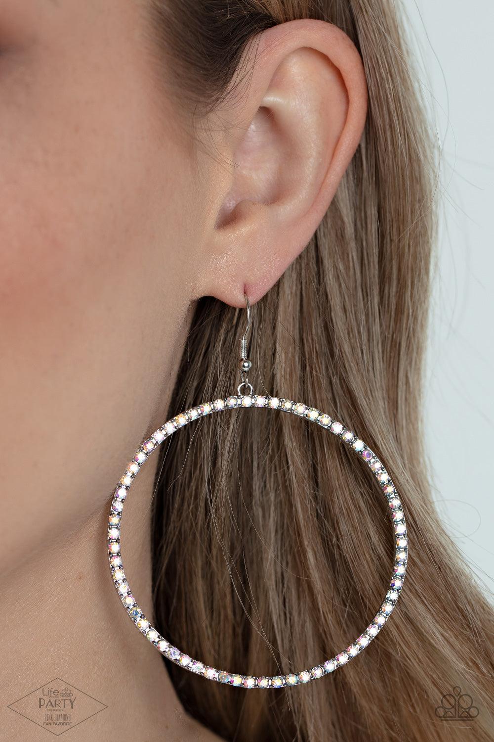 Paparazzi Accessories Wide Curves Ahead - Multi Encrusted in iridescent rhinestones, a dramatically oversized hoop swings from the ear for an exaggerated effect. Earring attaches to a standard fishhook fitting. Sold as one pair of earrings. Jewelry