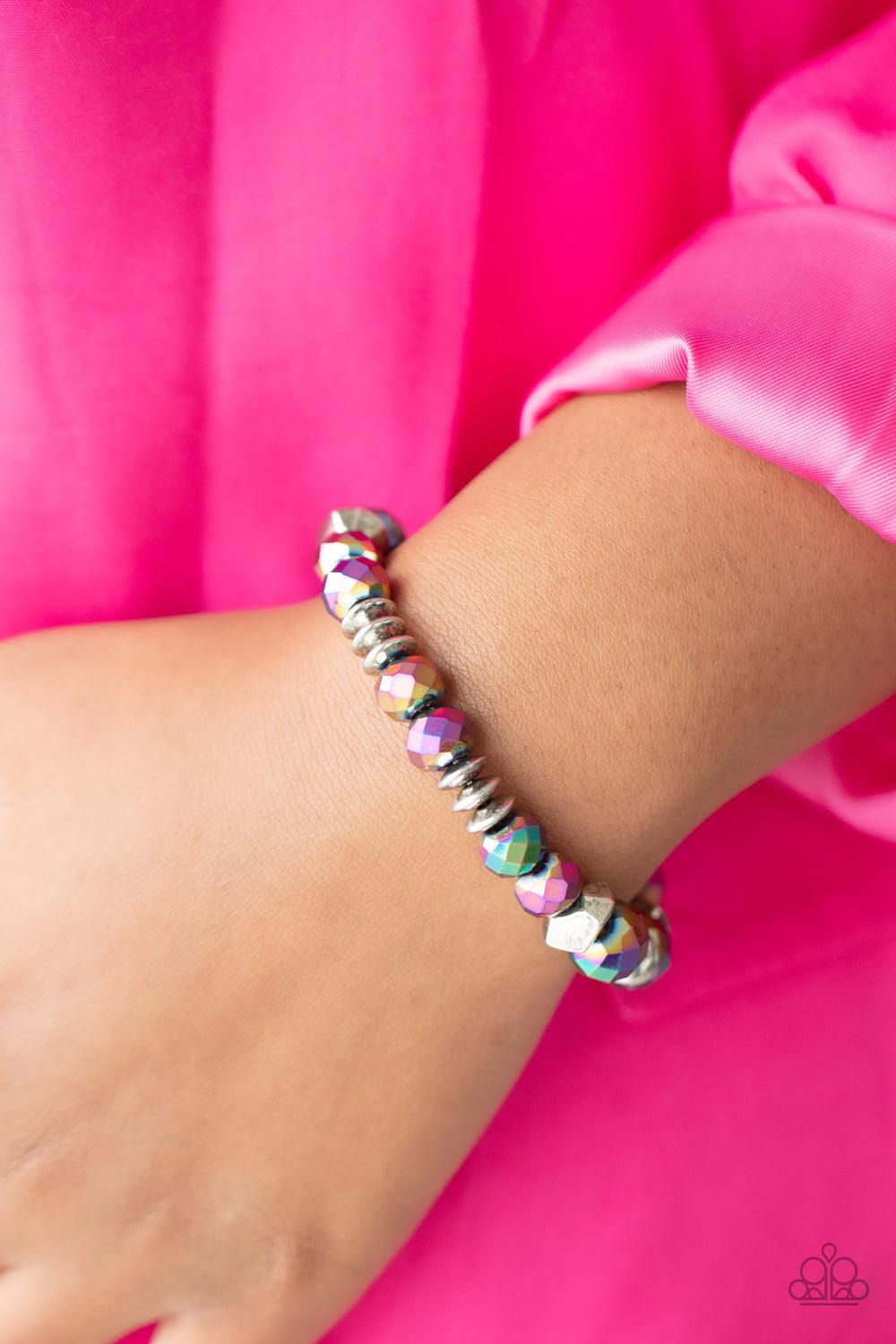 Paparazzi Accessories Astral Auras - Multi Separated by silver discs and faceted silver accents, faceted oil spill crystal-like gems are threaded along stretchy bands around the wrist for a stellar statement. Due to its prismatic palette, color may vary.