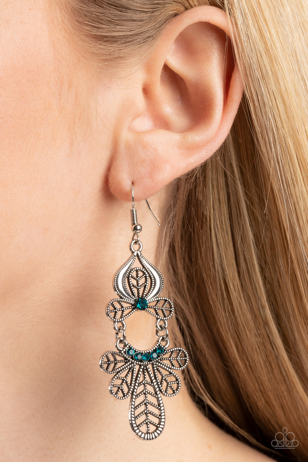 Paparazzi Accessories Galapagos Gala - Blue Studded leafy frames flare out from the bottom of a curved row of glittery blue rhinestones that swings from the bottom of a matching leafy silver frame. A solitaire blue rhinestone dots the uppermost frame, add