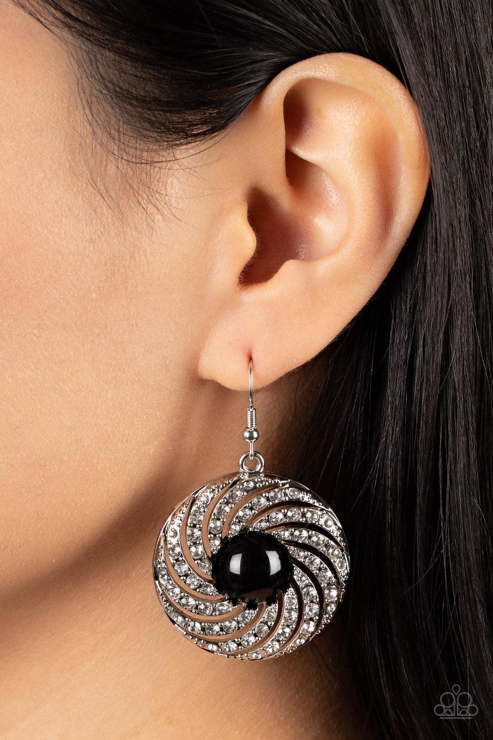 Paparazzi Accessories Vintage Vortex - Black Dotted in dainty silver studs, ribbons of white rhinestones whirl around an oversized black bead center for a hypnotic twinkle. Earring attaches to a standard fishhook fitting. Sold as one pair of earrings. Jew