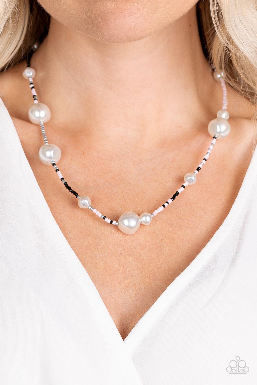 Paparazzi Accessories Modern Marina - Pink Irregular-shaped pearls in varying sizes are scattered amongst Gossamer Pink, black, and silvery seed beads that are threaded along a wire, resulting in a refreshing and playful style below the collar. Features a