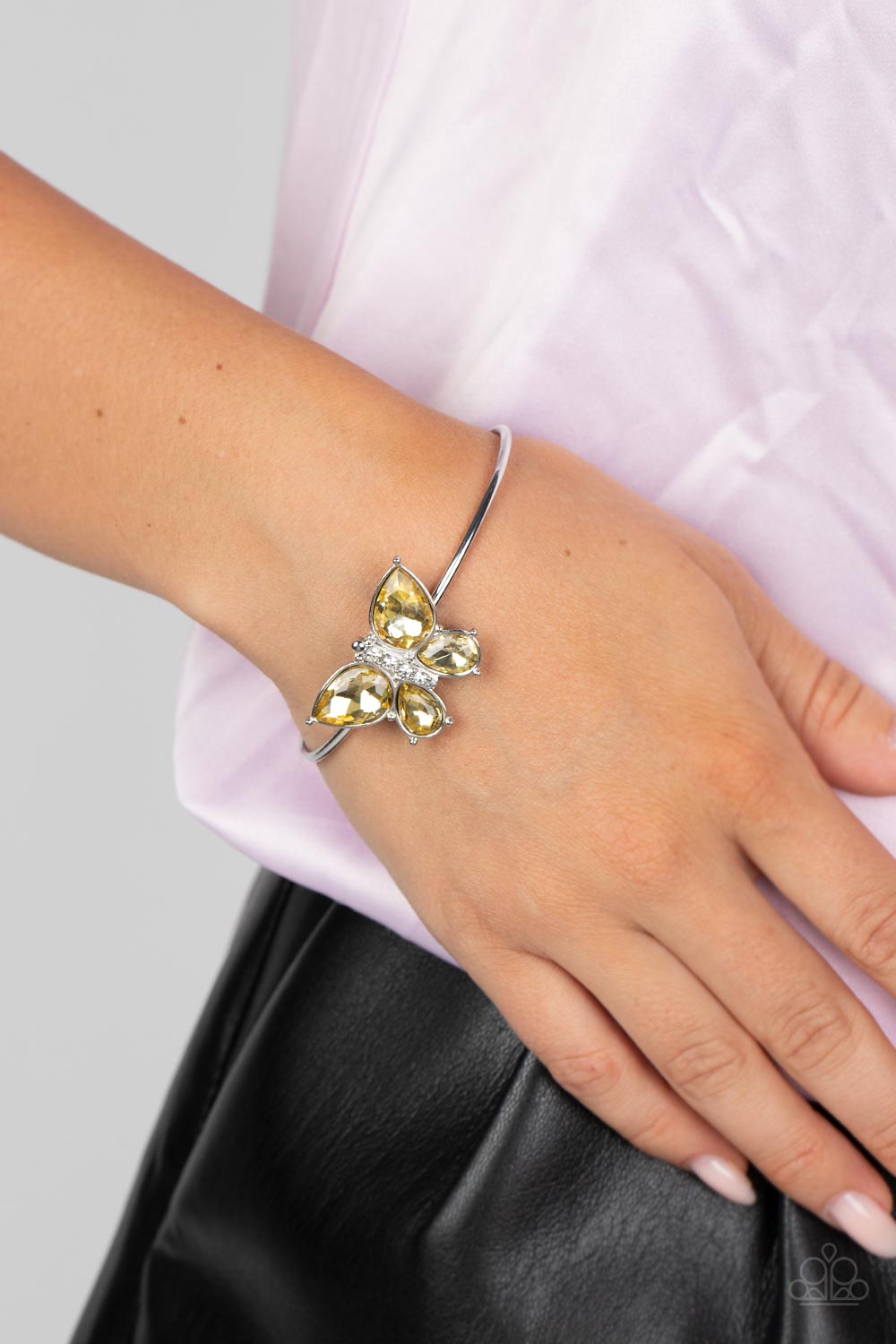 Paparazzi Accessories Butterfly Beatitude - Yellow A silver butterfly with yellow teardrop rhinestone wings and a white-rhinestone body delicately perches atop a shiny silver cuff. Sold as one individual bracelet. Get The Complete Look! Necklace: "Free-Fl