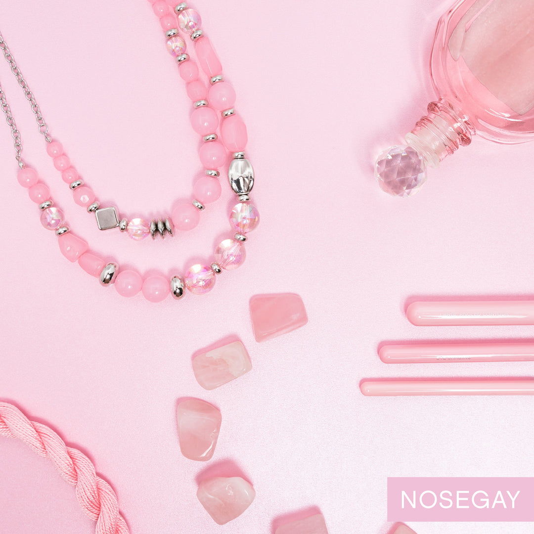 Paparazzi Accessories Mere Magic - Pink Featuring various shapes and finishes, a mismatched assortment of silver, iridescent, and opaque Gossamer Pink beads have been threaded along invisible wires below the collar, creating ethereal layers. Features an a