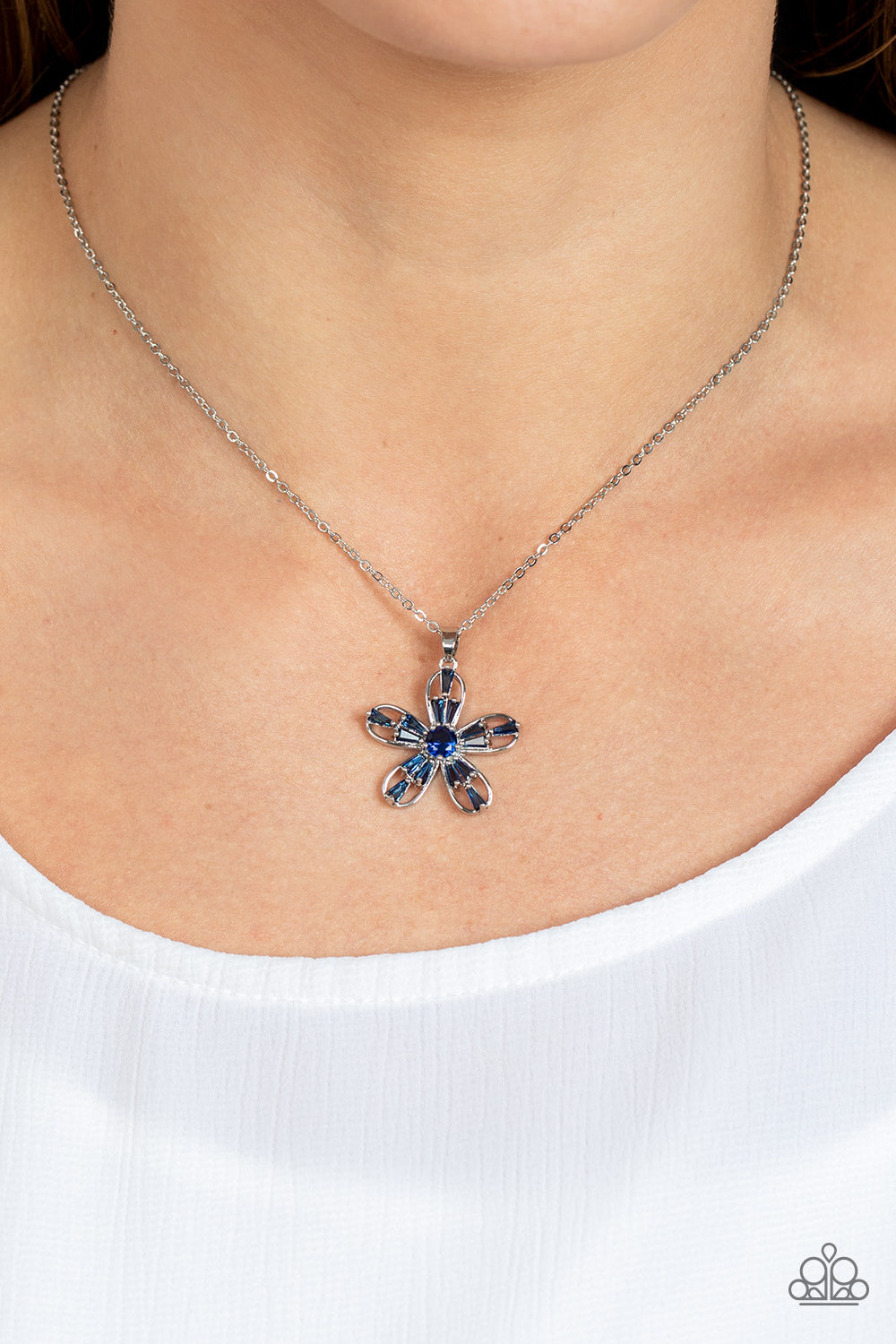 Paparazzi Accessories Botanical Ballad - Blue Emerald cut Skydiver rhinestones are scattered across the front of airy silver petals that bloom from a Skydiver rhinestone center, resulting in a sparkly floral pendant below the collar. Features an adjustabl