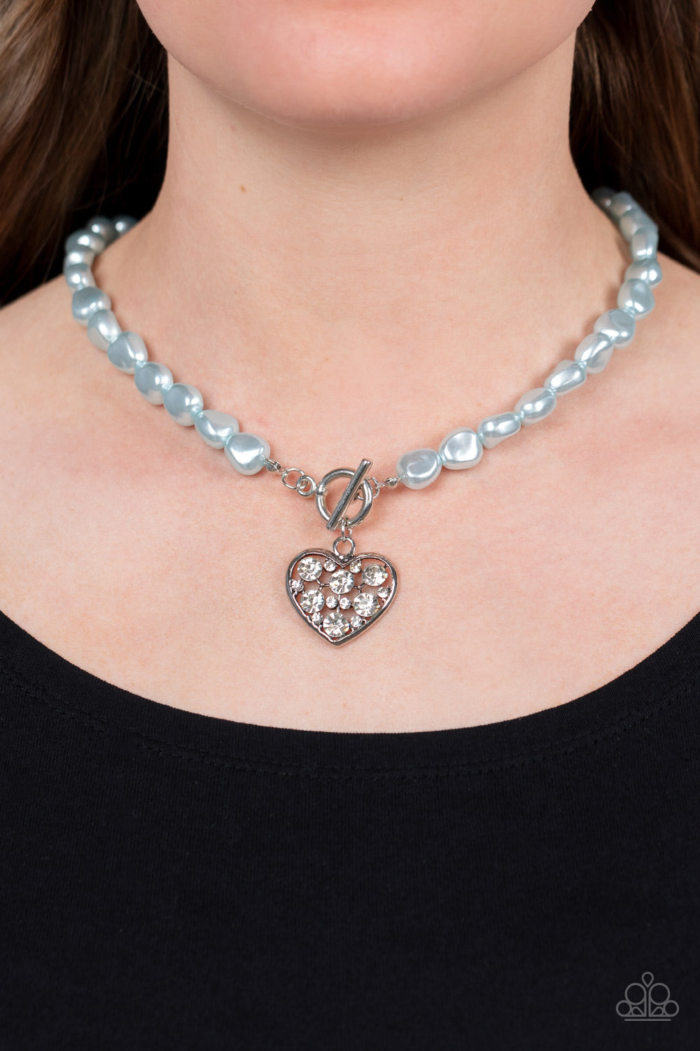 Paparazzi Accessories Color Me Smitten - Blue An imperfect collection of pearly blue beads are threaded along an invisible wire below the collar, creating a colorful display. Dotted in glittery white rhinestones, an airy silver heart pendant sparkles at t