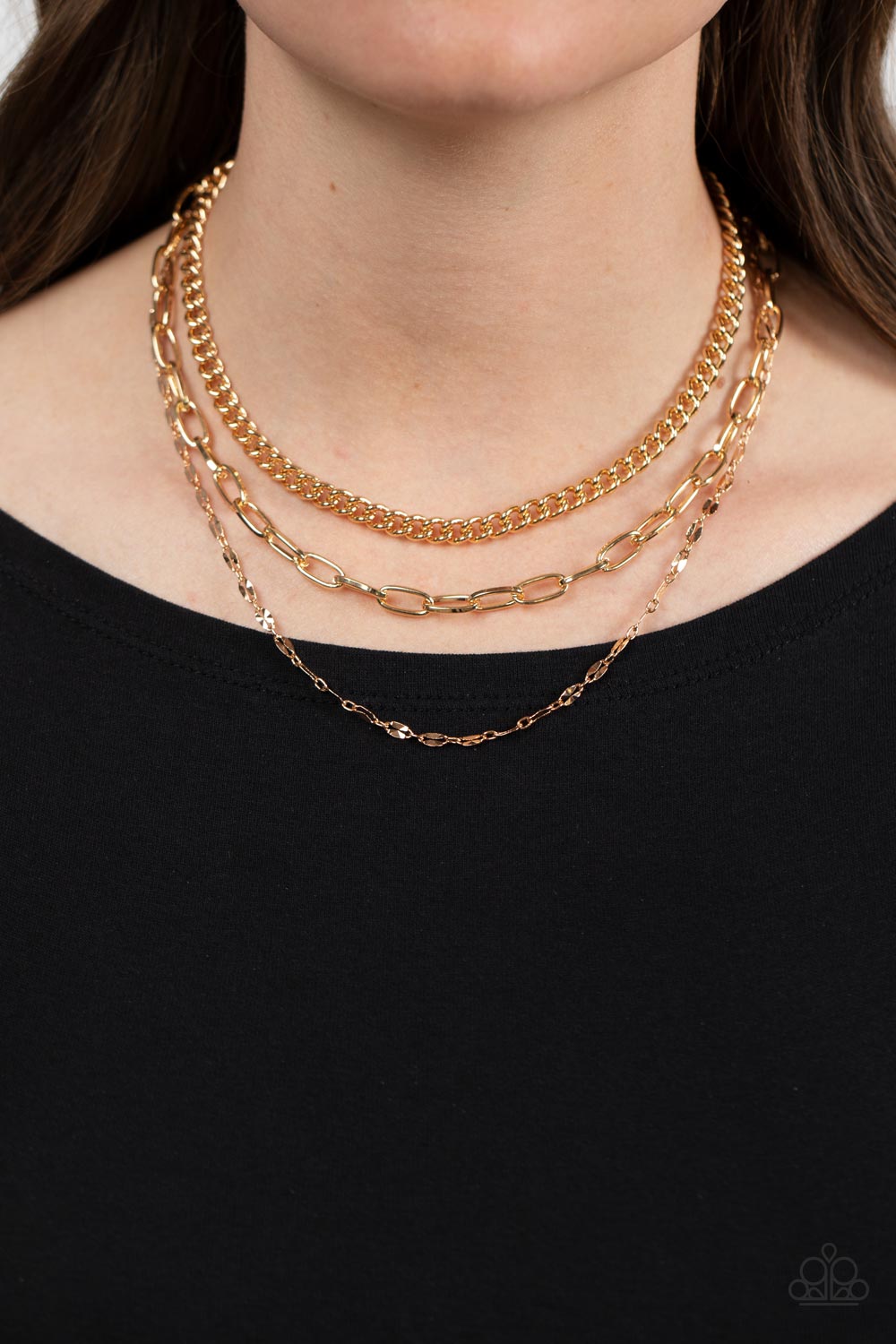 Paparazzi Accessories Galvanized Grit - Gold Three different kinds of weighted gold chains layer down the neck to create a gritty, edgy statement piece. Features an adjustable clasp closure. Sold as one individual necklace. Includes one pair of matching e