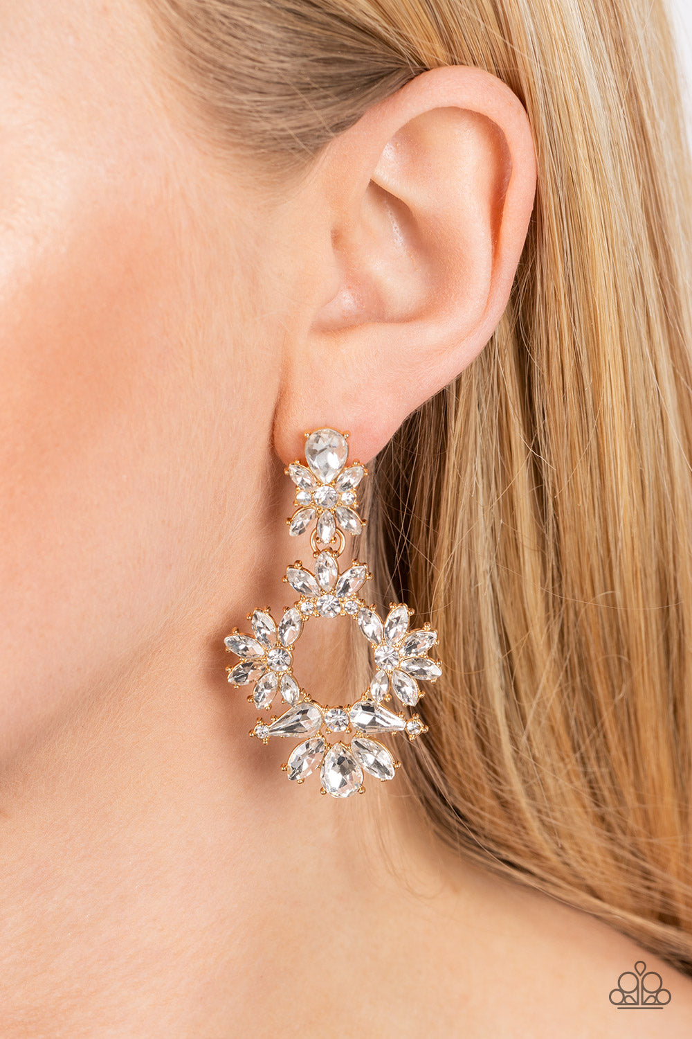 Paparazzi Accessories Leave them Speechless - Gold Ablaze with a mismatched assortment of brilliant white rhinestones, a stunning gold wreath swings from the bottom of a dainty white rhinestone fitting for a jaw-dropping dazzle. Earring attaches to a stan
