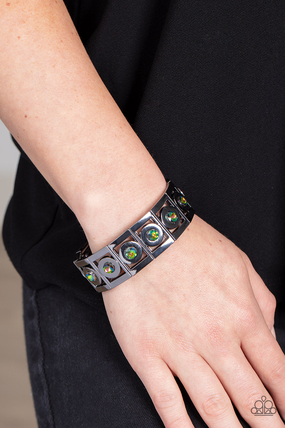 Paparazzi Accessories Stretch of Drama - Multi Vibrant oil spill rhinestones are encased in thick, circular gunmetal borders and nestled inside rectangular frames with the same metallic sheen. The frames are threaded along stretchy elastic bands, wrapping