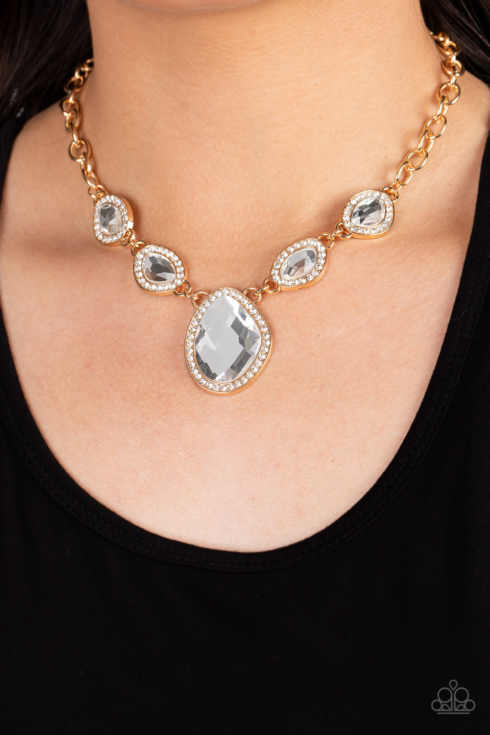 Paparazzi Accessories The Upper Echelon - Gold Bordered in gold frames dotted with tiny flecks of white rhinestones, a pair of asymmetrical white gems delicately link into a spellbinding sparkle around the neck. Features an adjustable clasp closure. Sold