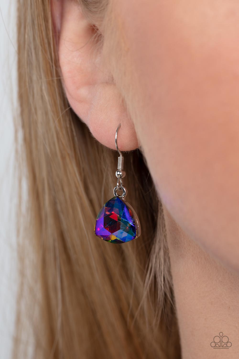Paparazzi Accessories Dreamy Drama - Blue A collection of dreamy trilliant-cut rhinestones in iridescent shades of blue and pink fall in line along the collar in a majestic finish. Features an adjustable clasp closure. Due to its prismatic palette, color