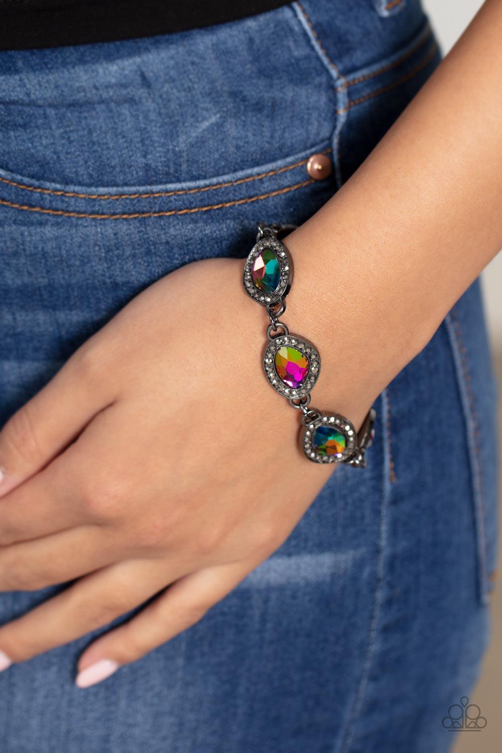 Paparazzi Accessories Next-Level Sparkle - Multi Bordered in gunmetal frames dotted with tiny flecks of hematite rhinestones, a collection of asymmetrical gems coated in an oil-spill finish delicately link into a spellbinding sparkle around the wrist. Fea