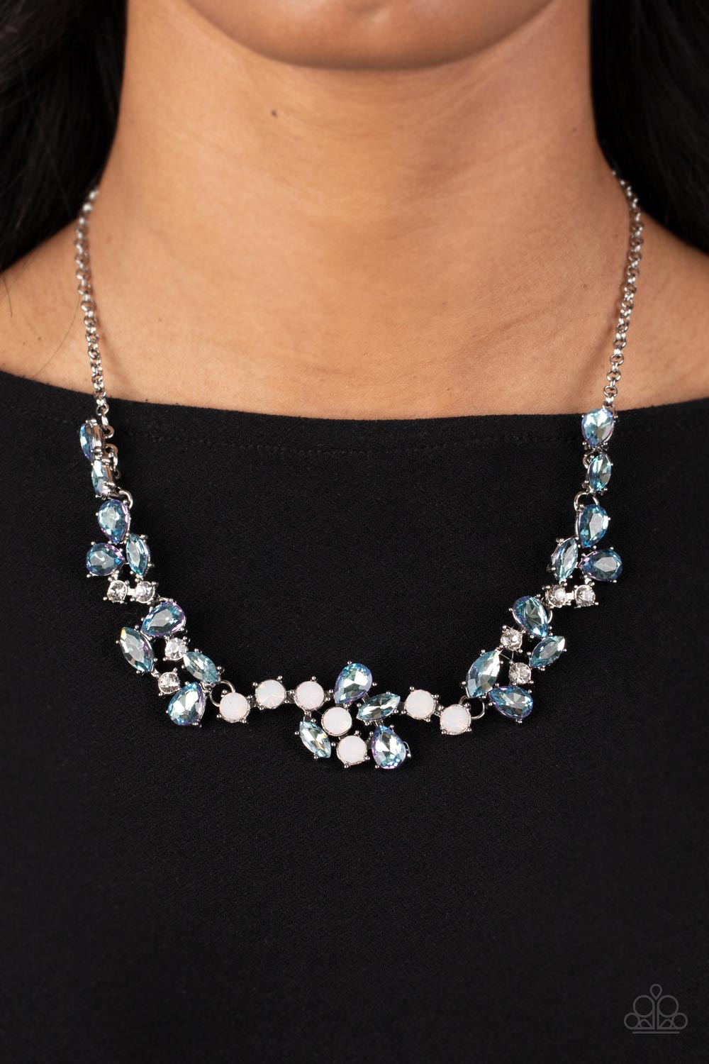 Paparazzi Accessories Welcome to the Ice Age - Blue Reflective frosty blue gems, white rhinestones, and gems with an opalescent finish gather together in a variety of inspired shapes into scattered clusters that connect across the collar. The edgy teardro