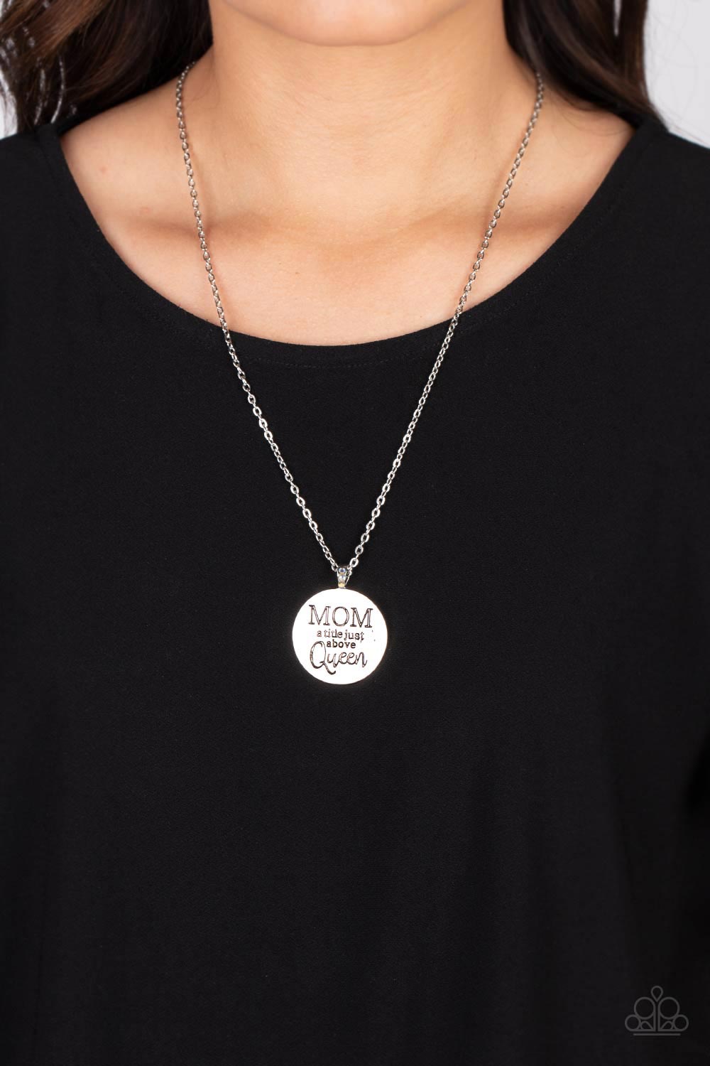 Paparazzi Accessories Mother Dear - Multi At the bottom of a shiny silver chain, a shiny silver disc is stamped with the phrase, "MOM a title just above Queen." The clasp attaching the disc to the chain features a collection of dainty iridescent rhineston