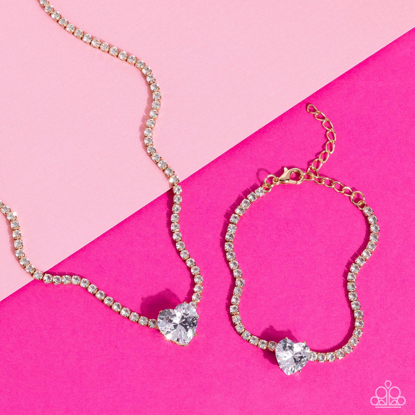 Paparazzi Accessories Flirty Fiancé - Gold An oversized white heart-shaped gem, set in an airy, pronged gold fitting, glitters at the center of a blinding row of dainty, glassy white rhinestones set in square gold fittings, resulting in a flirtatious spar