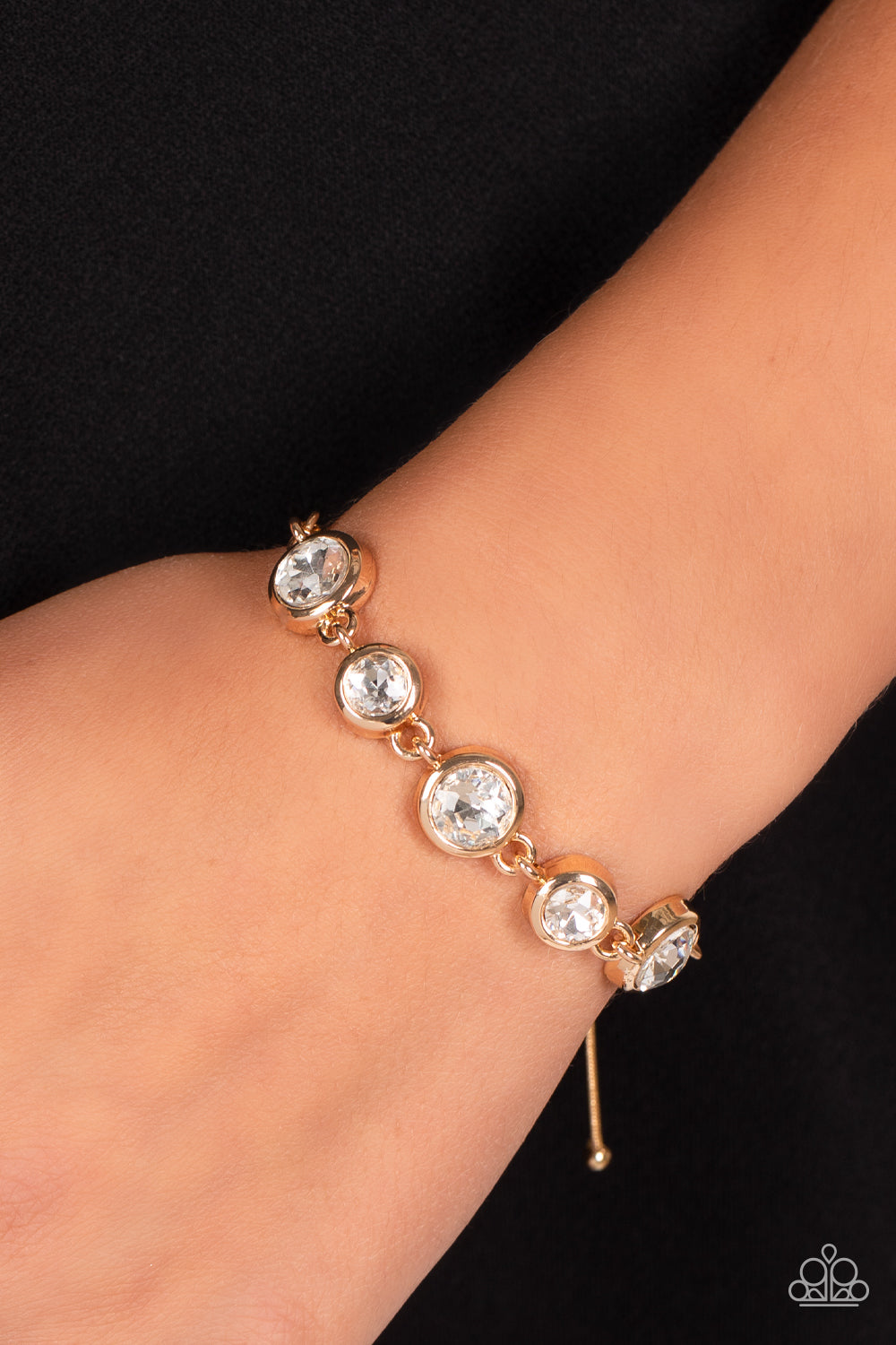 Paparazzi Accessories Classically Cultivated - Gold Varying sizes of classic, round, brilliant-cut white rhinestones set in thick, circular, gold frames link together around the wrist with glamorous glimmer. The rhinestones attach to a dainty strand of go