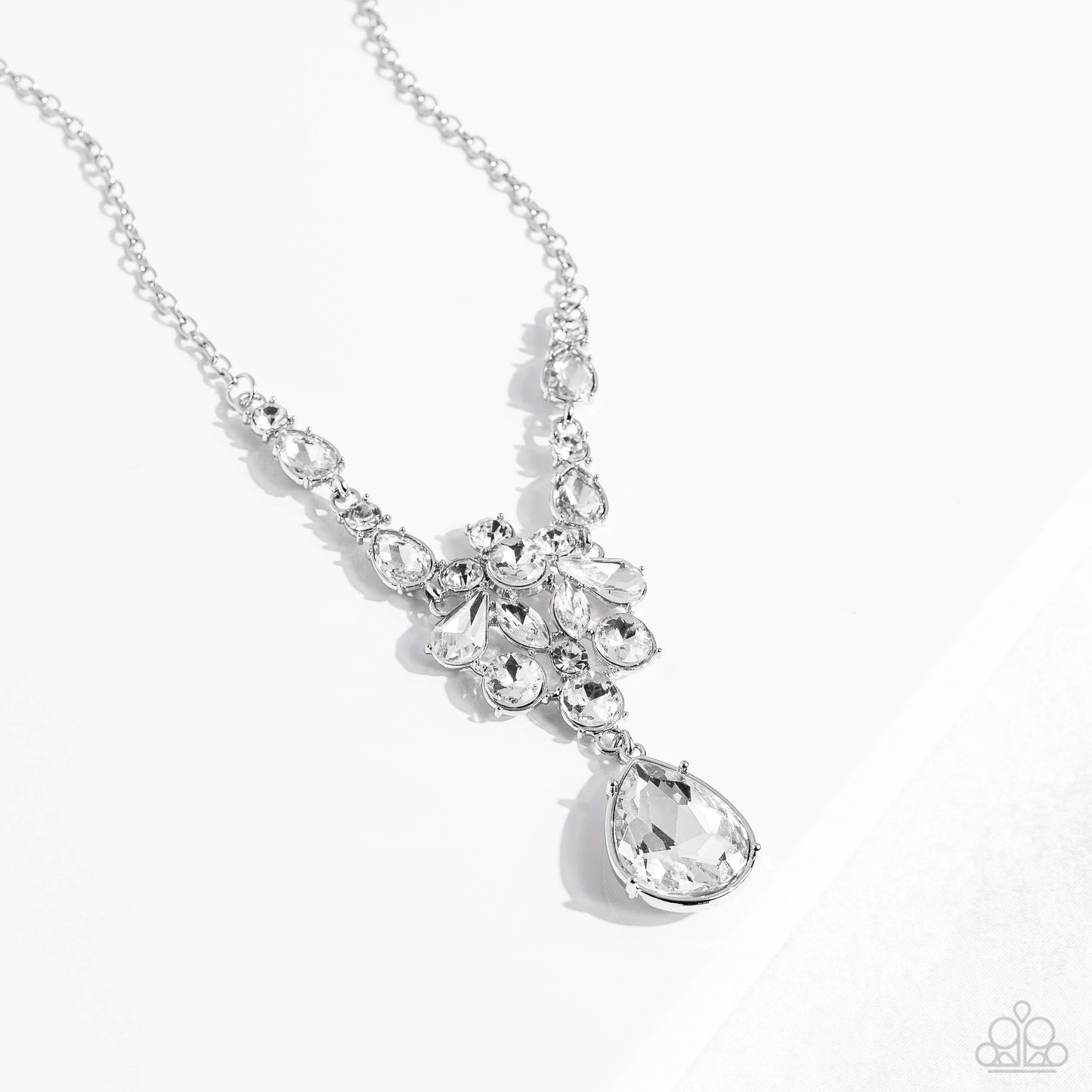 Paparazzi Accessories TWINKLE of an Eye - White Adorned with a dainty silver chain, a twinkling collection of white, reflective teardrops, rhinestones and marquise-cut gems glitter down the chest. Hanging at the bottom of the glittery collection, an overs