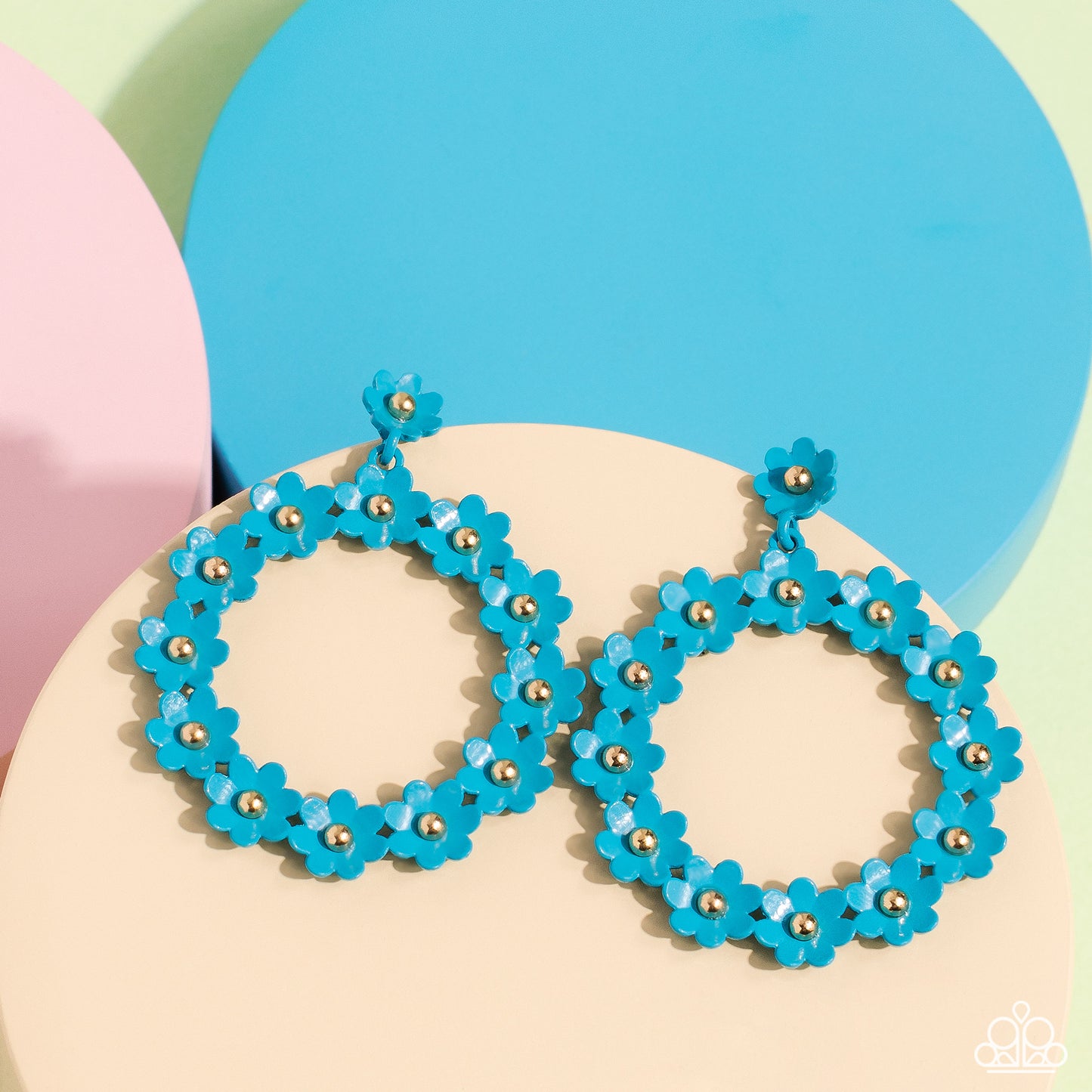 Paparazzi Accessories Daisy Meadows - Blue Hanging from a solitaire blue daisy, a dainty collection of blue daisies bloom into a free-spirited wreath below the ear. Gold studs gleam from the centers of the tactile flowers, adding an industrial sheen to th