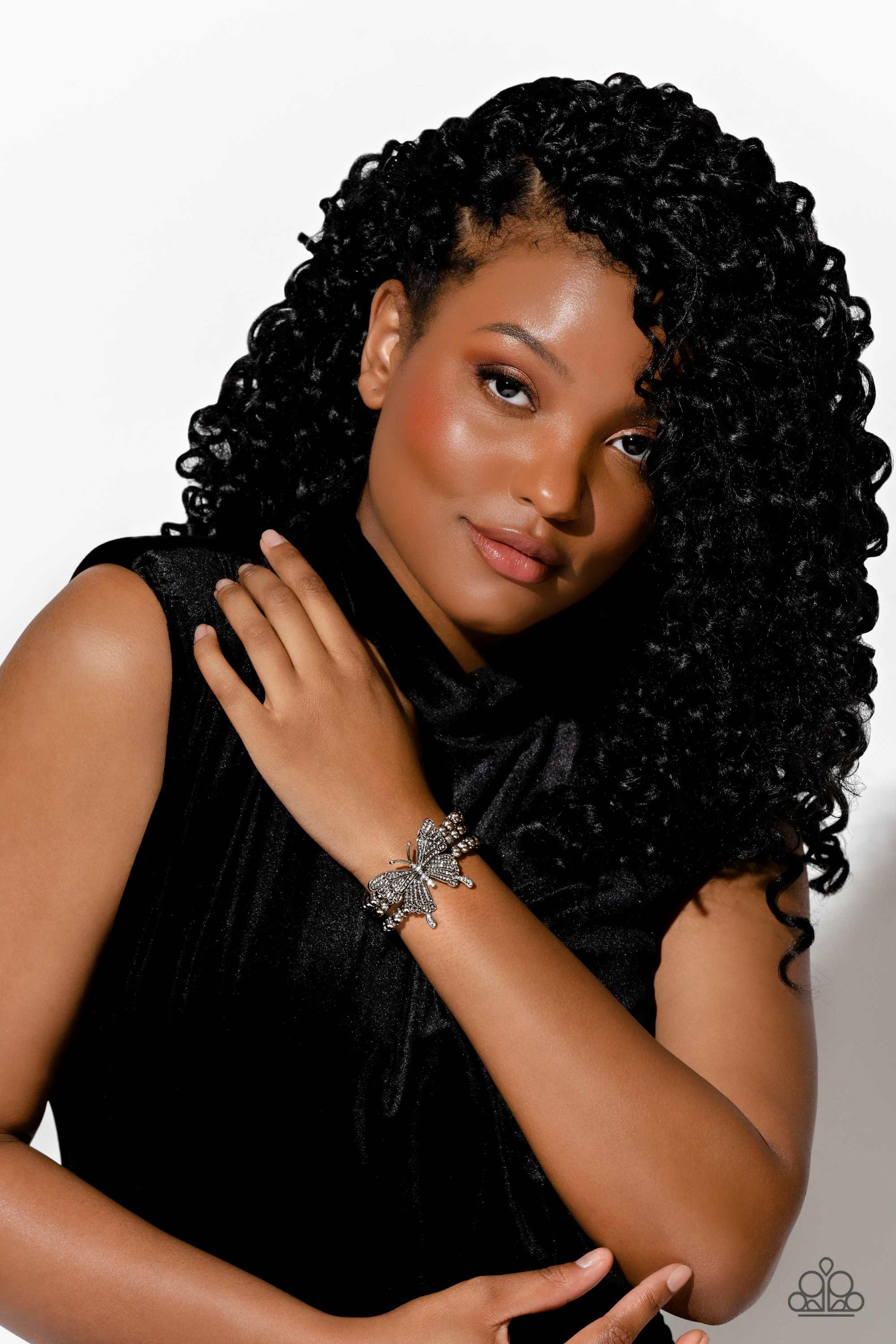 Paparazzi Accessories First WINGS First - White Strung along elastic stretchy bands, a trio of silver and textured silver beads and accents wrap around the wrist. Featured atop the beaded collection, an oversized silver butterfly, with intricate details,