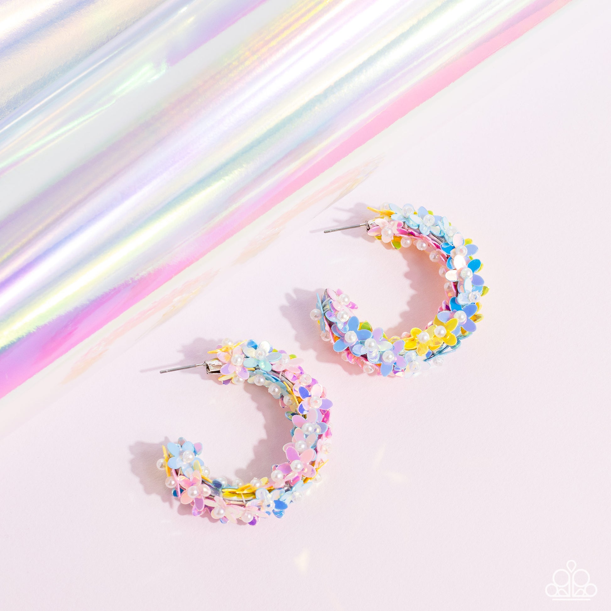Paparazzi Accessories Fairy Fantasia - Multi A floral explosion, encompassing the entirety of a thick silver hoop, features reflective light blue, pink, and yellow flowers dotted with dainty pearl centers for a dreamy, whimsicality below the ear. Earring