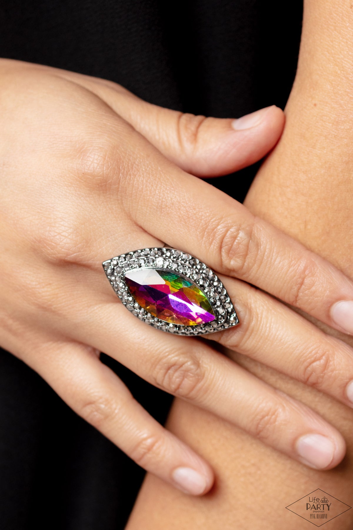 Paparazzi Accessories Jaw-Dropping Dazzle - Multi 2 Featuring a UV shimmer, a dramatic gem is pressed into the center of stacking gunmetal frames encrusted in row after row of hematite rhinestones for a blinding look. Features a stretchy band for a flexib