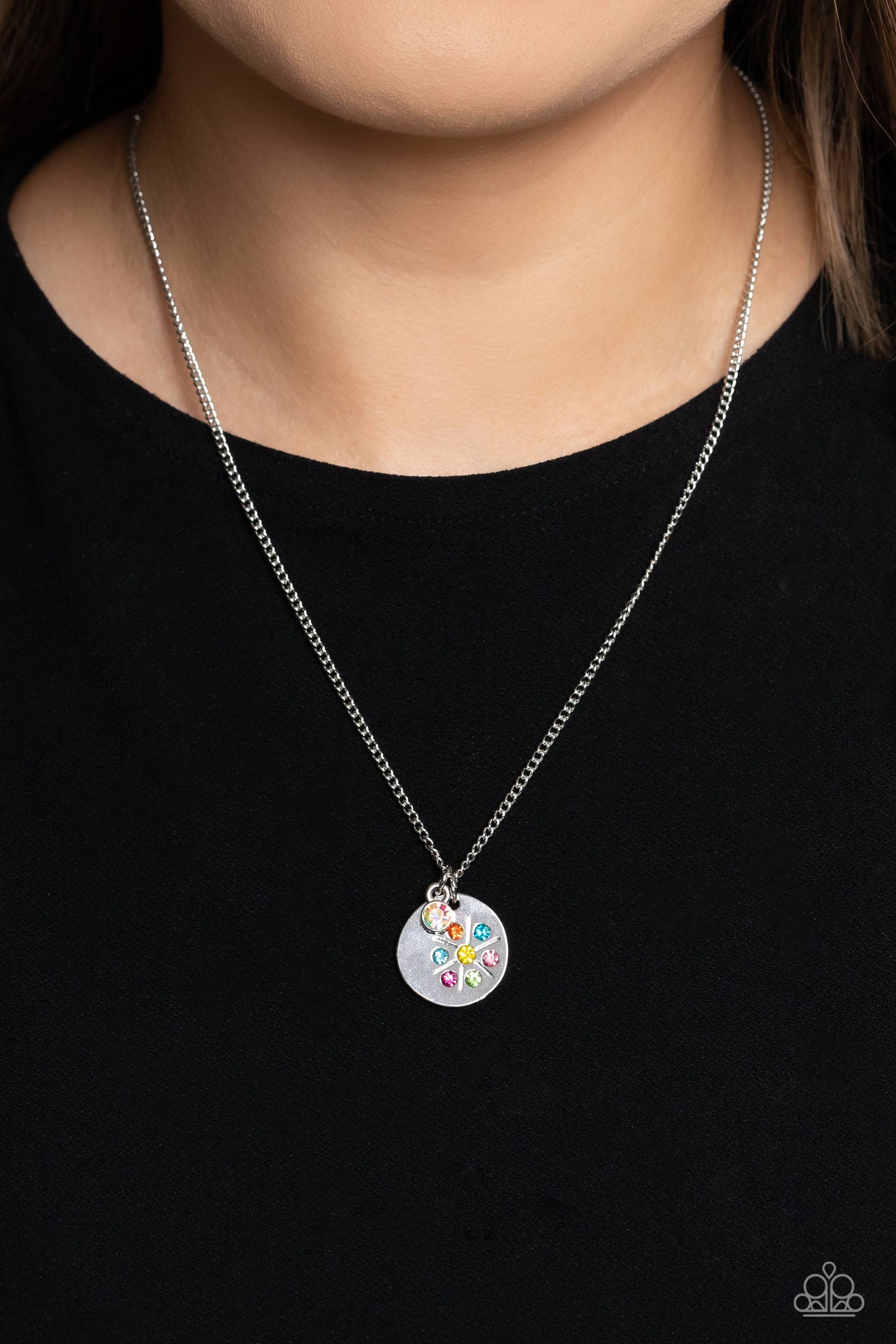 Paparazzi Accessories Dandelion Delight - Multi Falling from a dainty silver chain, a silver disc is embossed with colorful rhinestones that encircle around a dandelion stamped shape. Gliding next to the silver disc, a solitaire iridescent rhinestone set