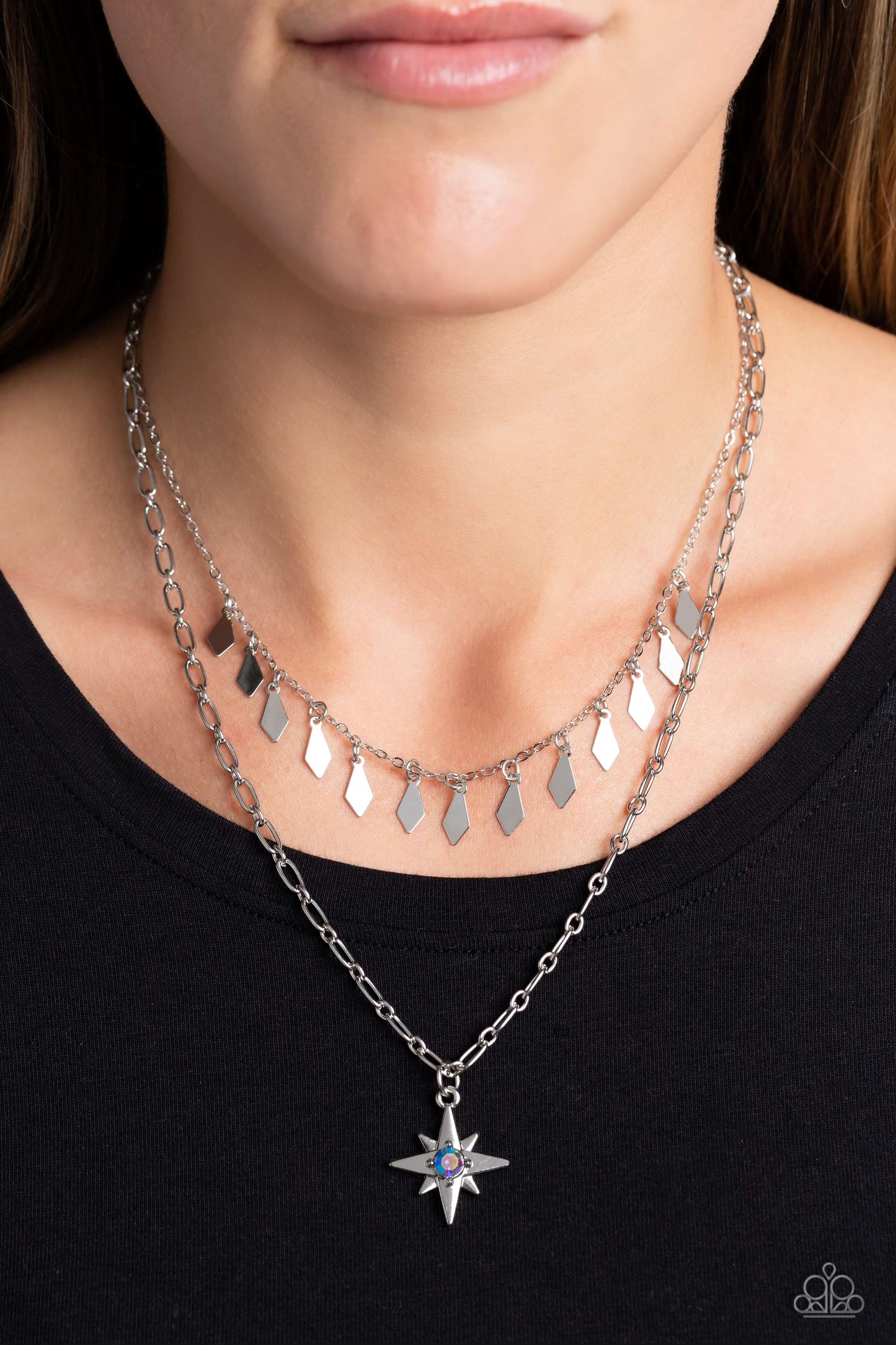 Paparazzi Accessories The Second Star To The LIGHT - Blue A three-dimensional silver star, dotted with a single blue-iridescent rhinestone glides on a paperclip chain down the neckline for an out of-this-world vibe. Flat and flared silver frames dance abo