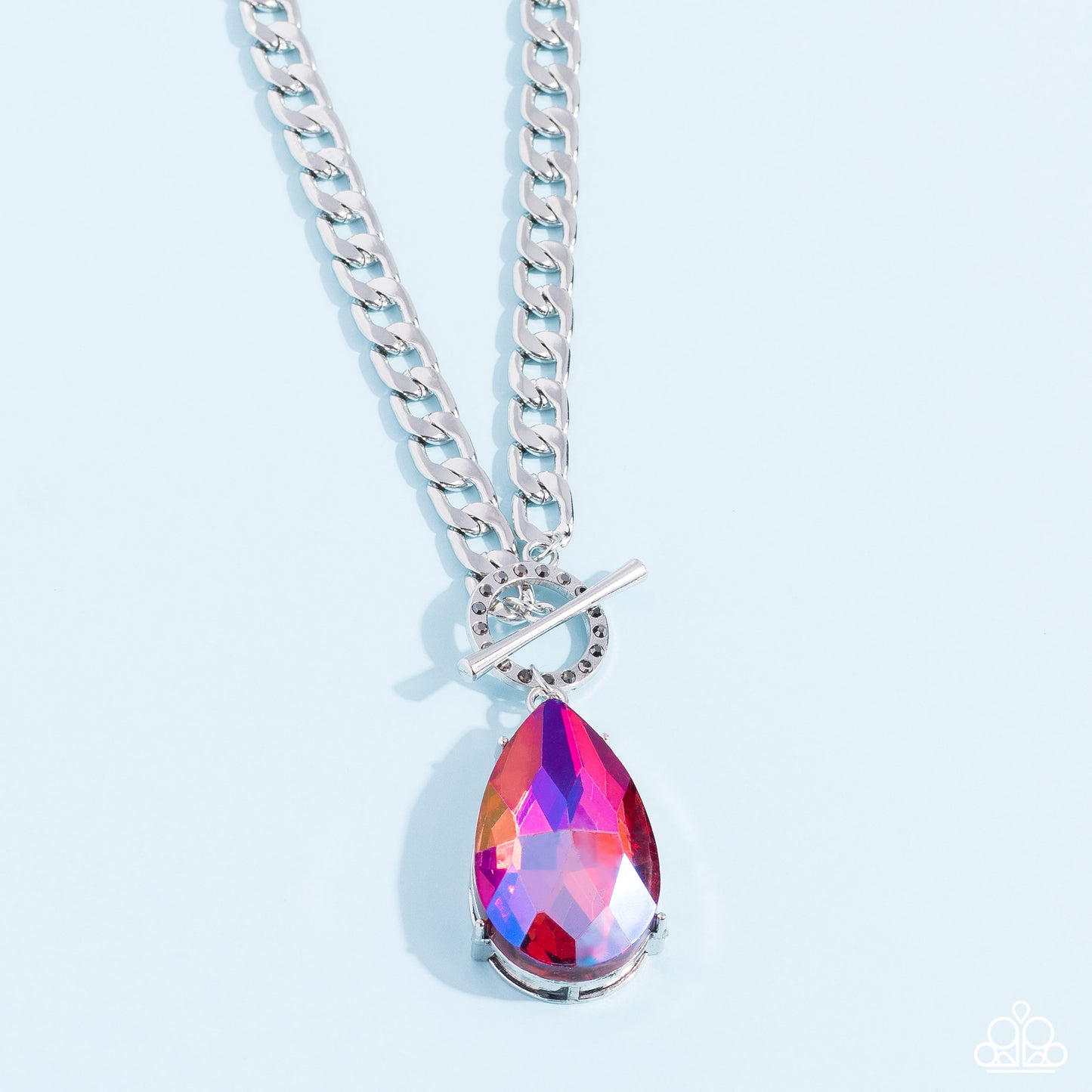 Paparazzi Accessories Edgy Exaggeration - Pink Featuring an elegant lariat closure, an oversized, faceted, stellar pink UV shimmery teardrop gem, encased in an elevated pronged silver frame cascades from the bottom of a silver curb chain in a whimsical fa