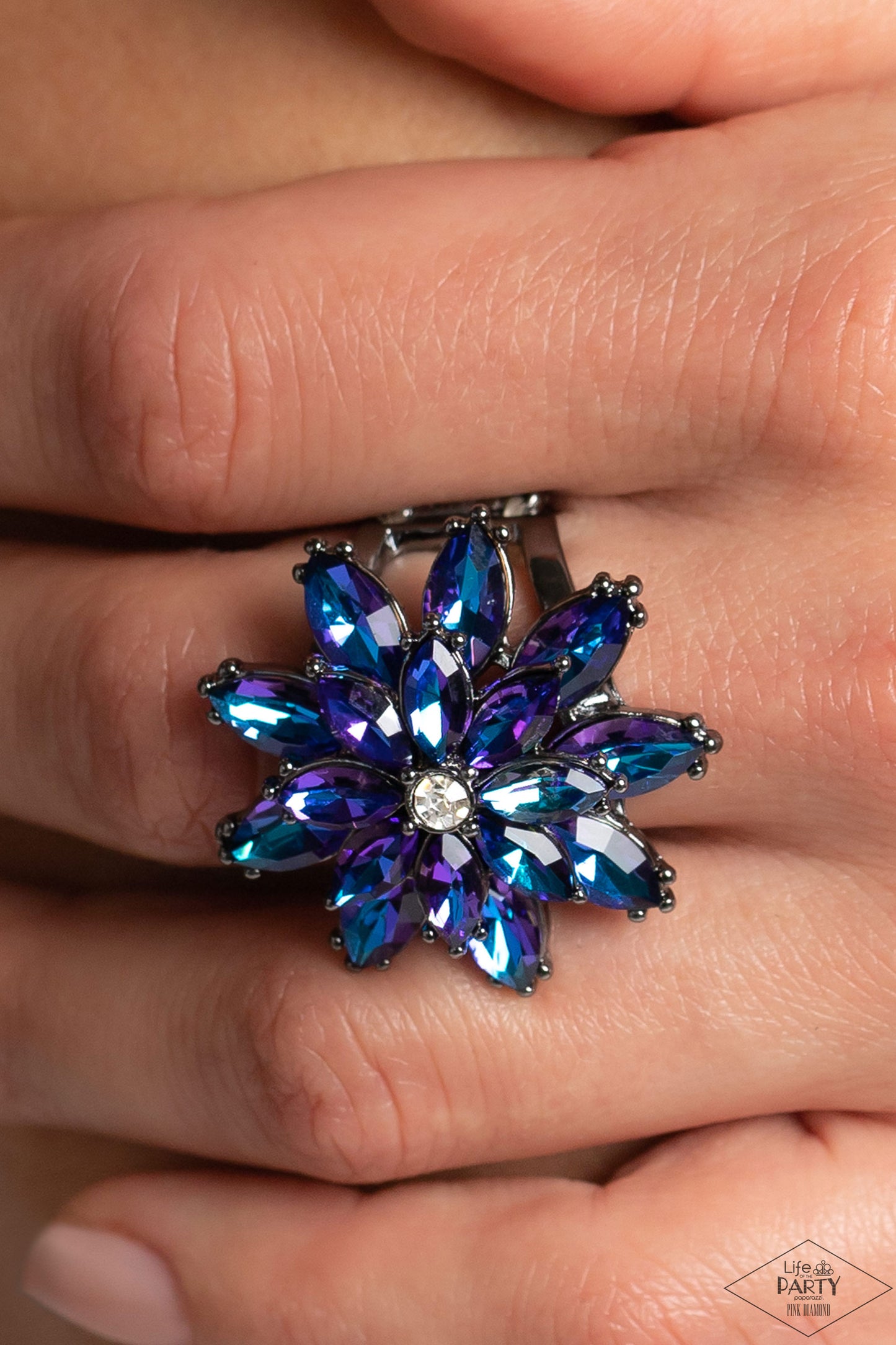 Paparazzi Accessories Am I GLEAMing? - Multi Glittery blue iridescent rhinestone petals stack into a glamorous floral frame atop the finger, creating a blinding centerpiece. Features a stretchy band for a flexible fit. Due to its prismatic palette, color
