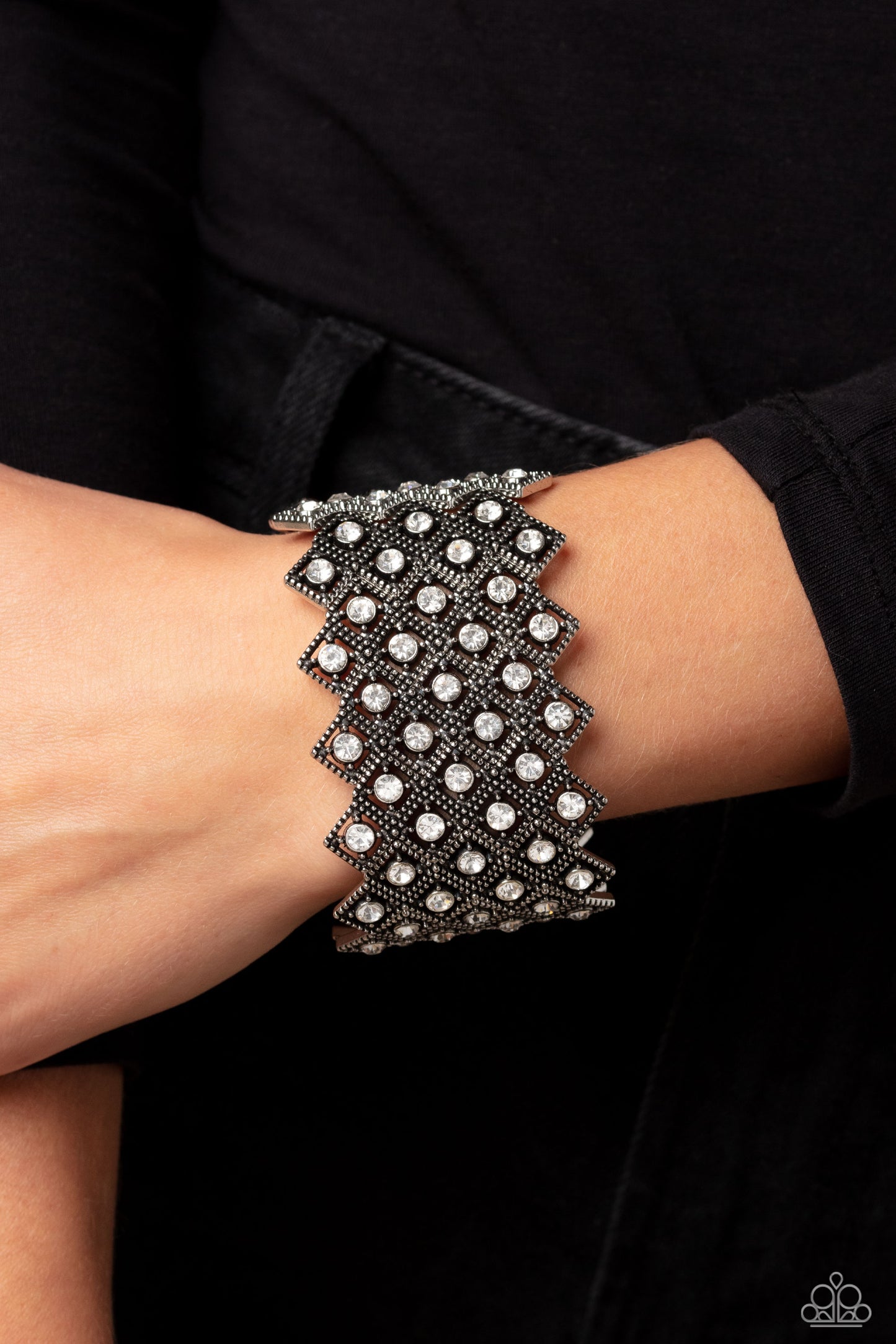 Paparazzi Accessories DECO in the Rough - White Glittery silver-studded diamond frames filled with white rhinestones cluster together in a geometric pattern around the wrist on elastic stretchy bands for a glitzy art deco finish. Sold as one individual br