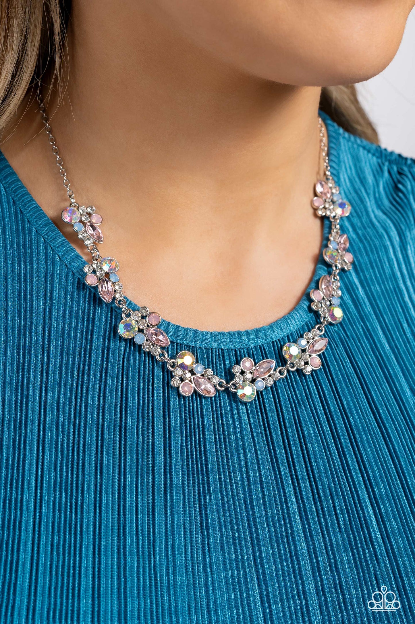 Paparazzi Accessories Swimming in Sparkles - Multi An eclectic collection of white, blue, iridescent and light peach round rhinestones in varying sizes and marquise-cut gems in a light pink shade cluster around the collar in high-sheen silver frames. Patt