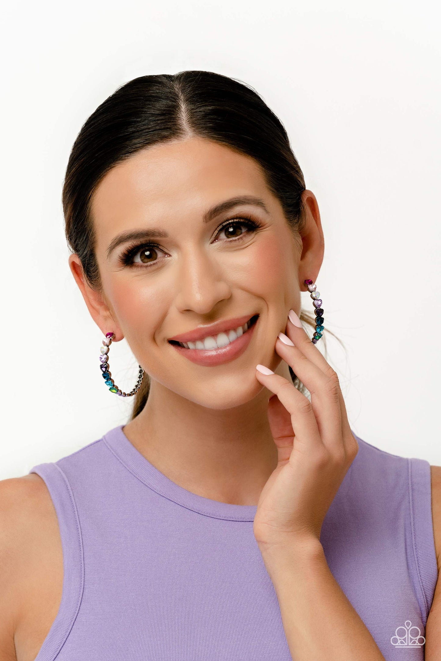 Paparazzi Accessories Hypnotic Heart Attack - Multi Featuring a scalloped heart frame, glittery heart rhinestones in shades of pink, iridescence, purple, blue, and a refracted green shimmer slowly decrease in size as they curve down the ear to meet dainty