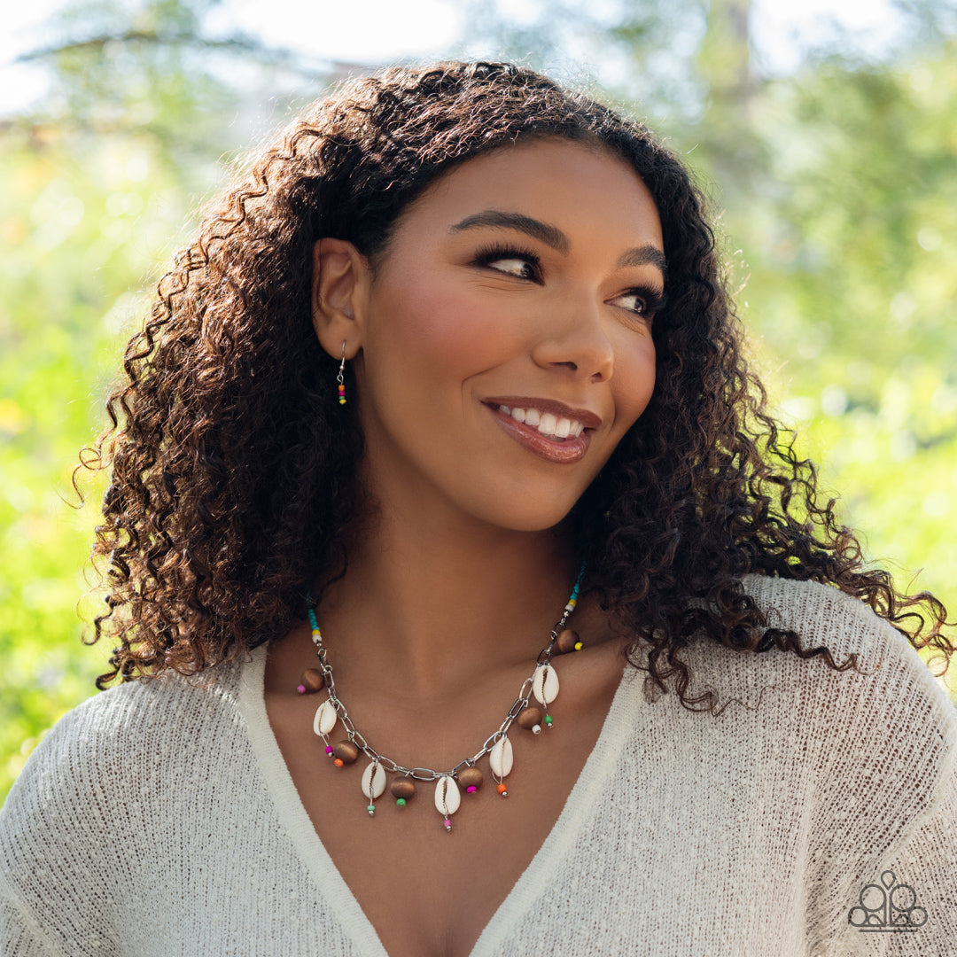 Paparazzi Accessories BEACH for the Sun - Blue Vibrant blue, white, and yellow seed beads connect to a silver link chain. Dangling along the silver links, wooden beads and cowrie shells alternate for a beach-inspired statement. Colorful seed beads dangle
