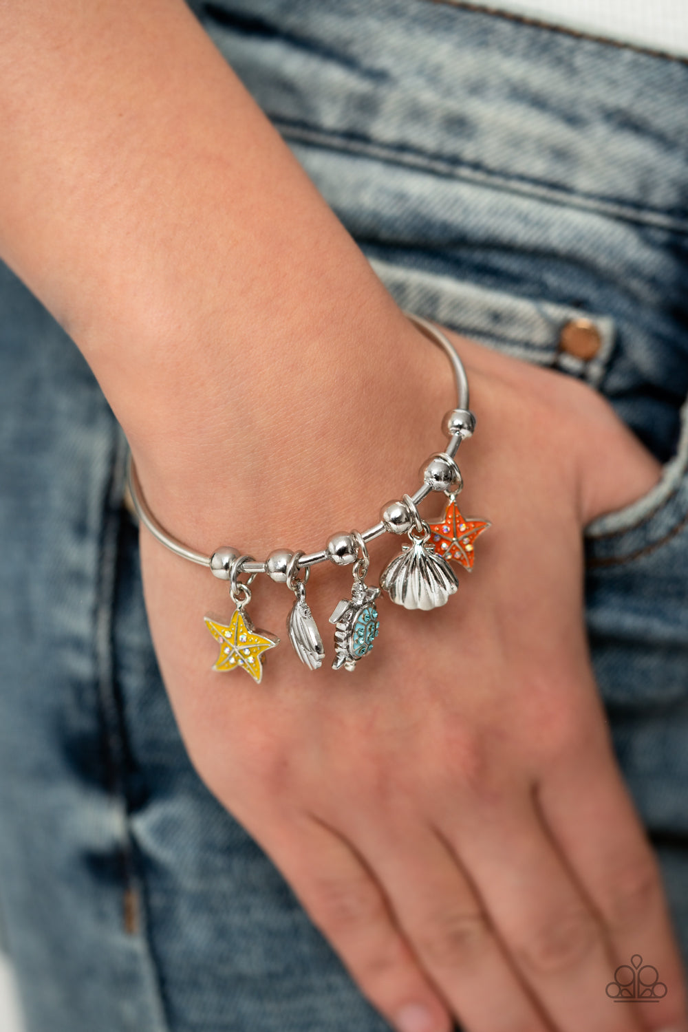 Paparazzi Accessories Swimming in Shimmer - Multi A skinny silver bar with barbell fittings arcs across the wrist, creating a dainty cuff. Secured in place by silver beads, silver sea scallop seashells, starfish in shades of burnt coral and yellow with a