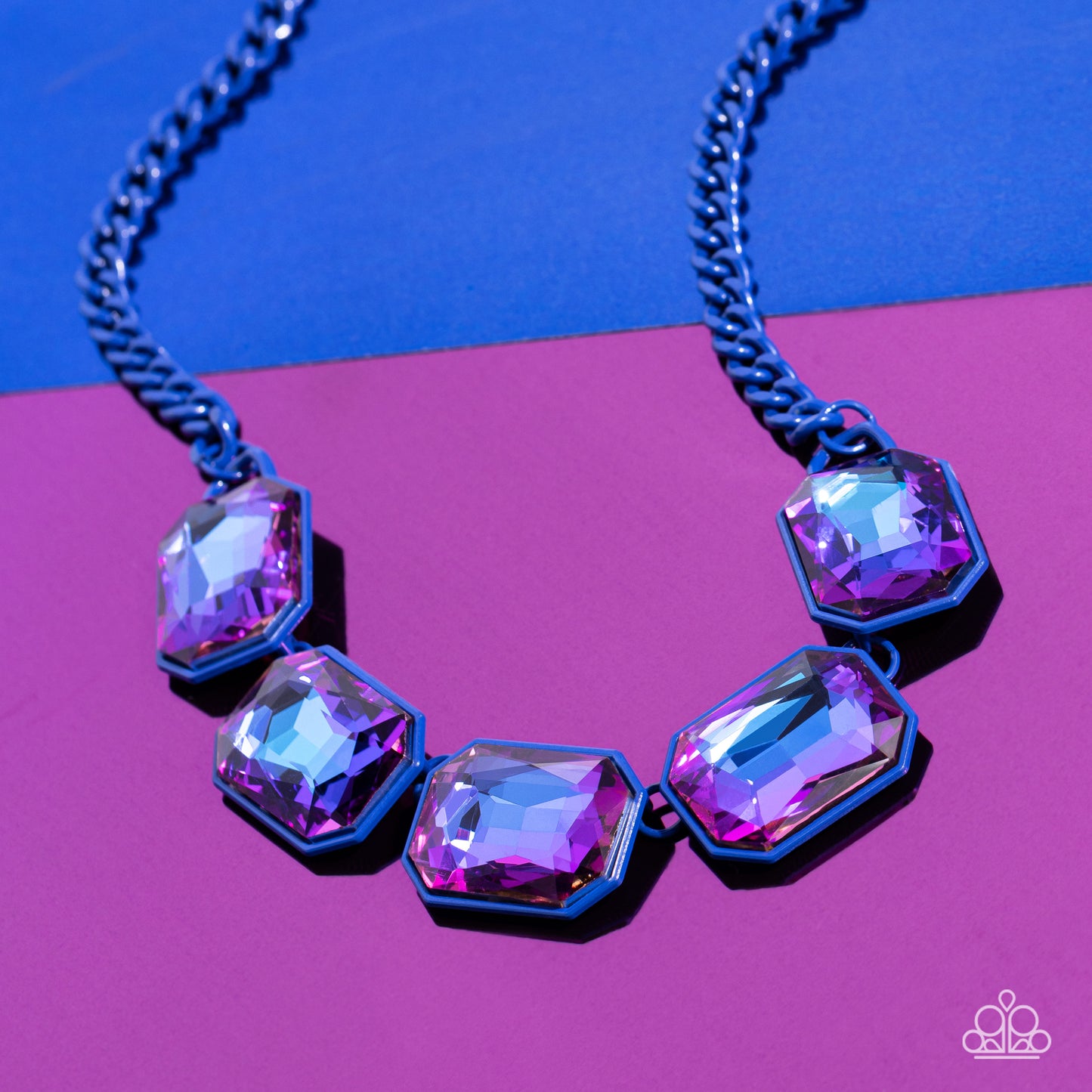 Paparazzi Accessories Emerald City Couture - Blue Featuring a vivacious blue chain, a collection of purple UV shimmery emerald-cut gems, pressed in vibrant blue frames, coalesces around the collar to create a playful pop of edgy color. Features an adjusta