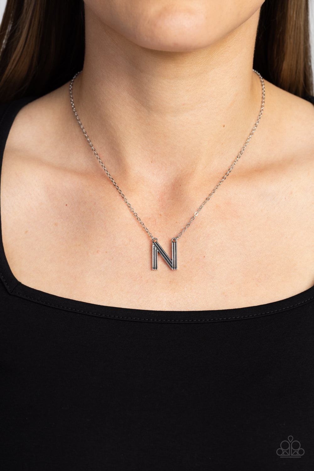 Paparazzi Accessories Leave Your Initials - Silver - N Etched in linear texture, a silver letter "N" hovers below the collar from a dainty silver chain, for a sentimentally simple design. Features an adjustable clasp closure. Sold as one individual neckla