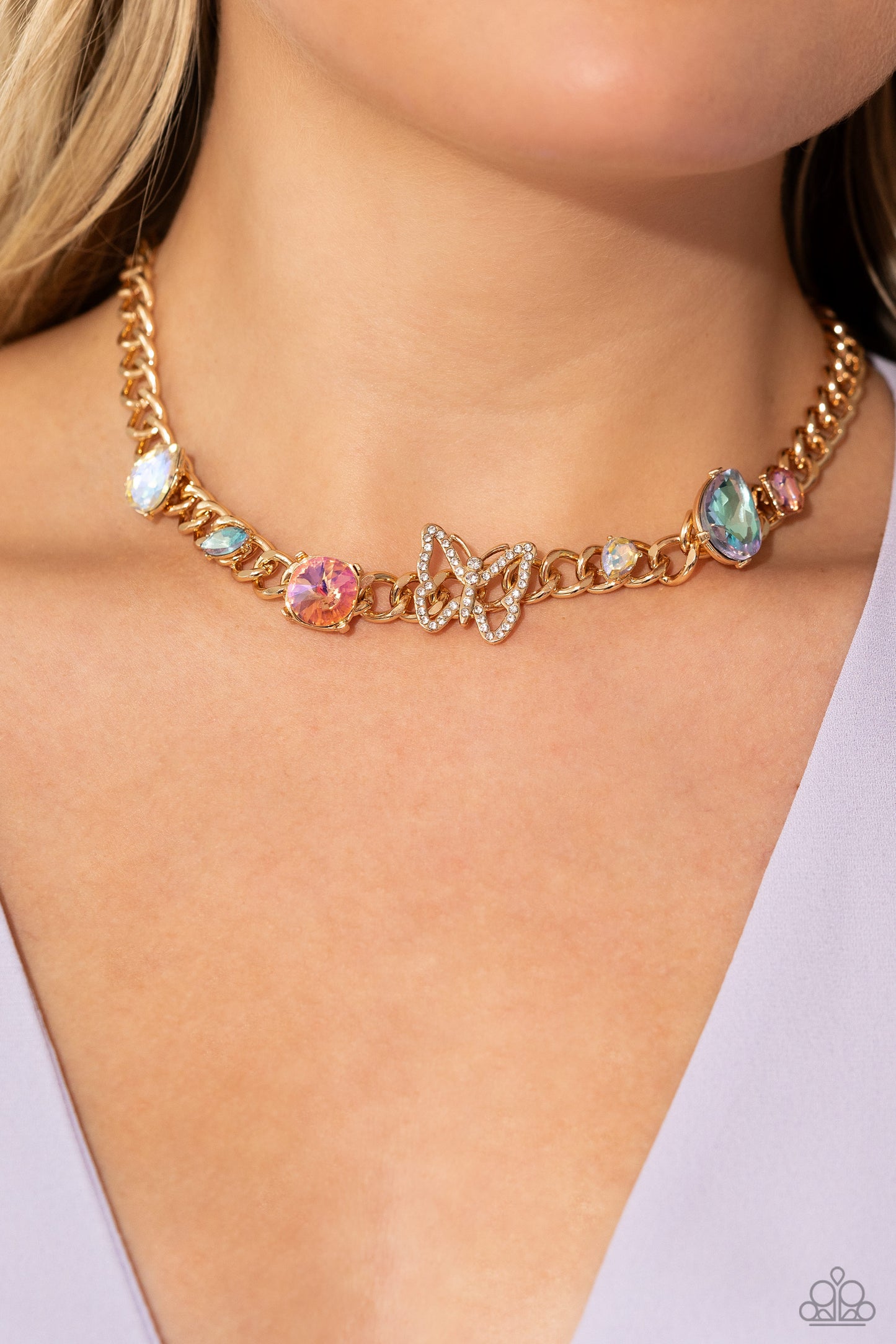 Paparazzi Accessories Storybook Succession - Gold A succession of various gleaming, multicolored gems encased in gold fittings are affixed to a high-sheen, thick gold curb chain, adding dramatic dimension and color to an industrial statement. An airy gold